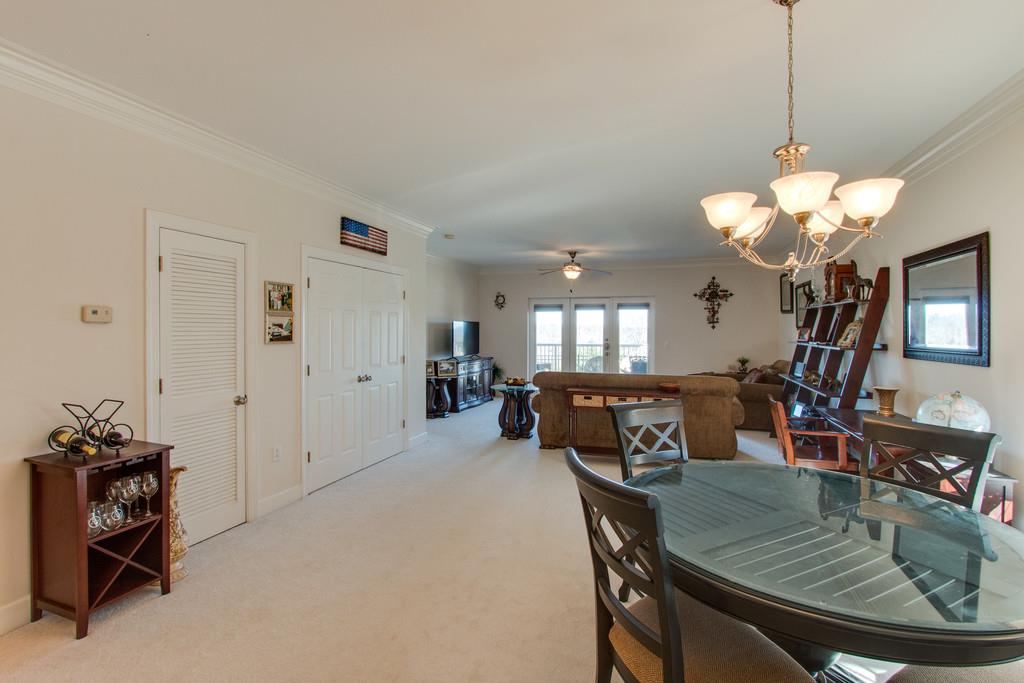 7100 Dale Ridge Road, Unit C2 Lancaster, TN 38569 - Photo 7 of 24 a dining room with wooden floor a chandelier a wooden table and chairs