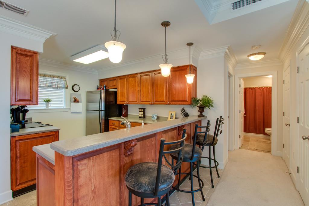 7100 Dale Ridge Road, Unit C2 Lancaster, TN 38569 - Photo 8 of 24 a kitchen with stainless steel appliances a dining table chairs and a refrigerator