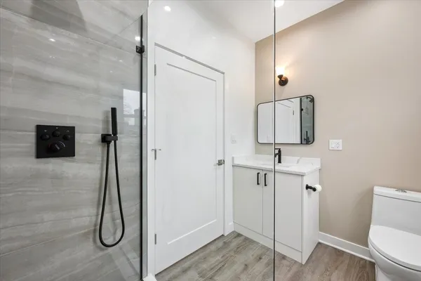 a bathroom with a shower sink and mirror