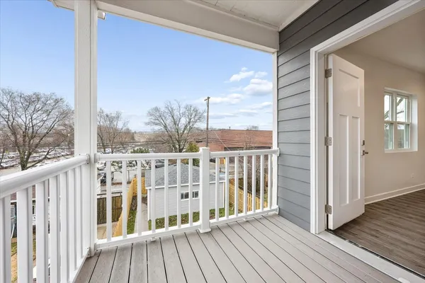 a view of a balcony with wooden floor