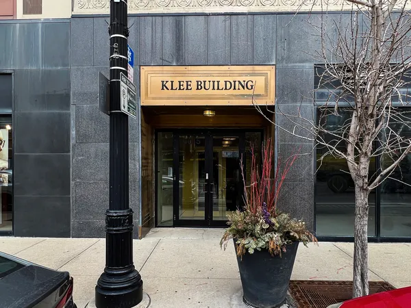 a picture of a bench in front of a building