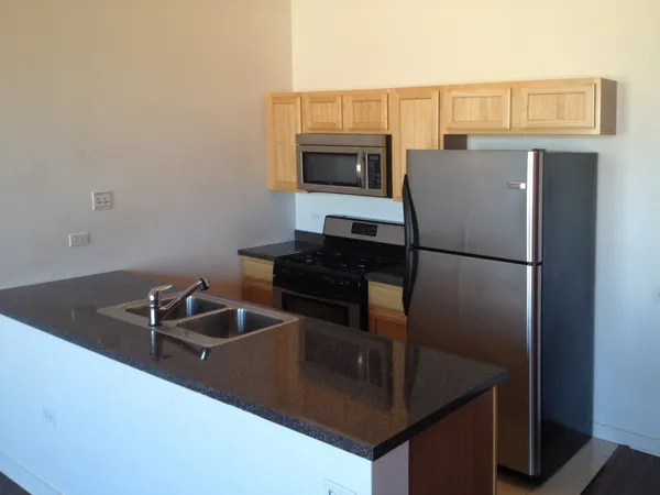 a kitchen with a refrigerator and a sink