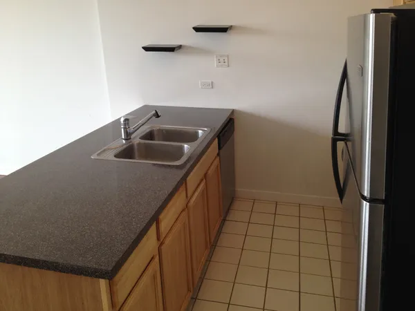 a kitchen with a sink a refrigerator freezer a washer and dryer