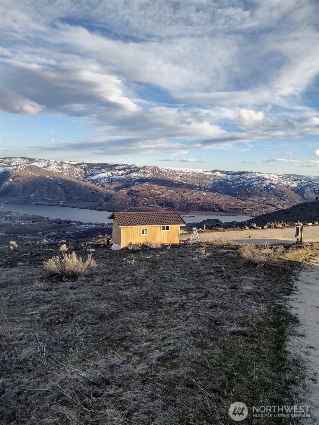 a view of a lake with trees in the background