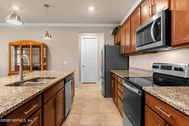 a kitchen with granite countertop stainless steel appliances and a sink
