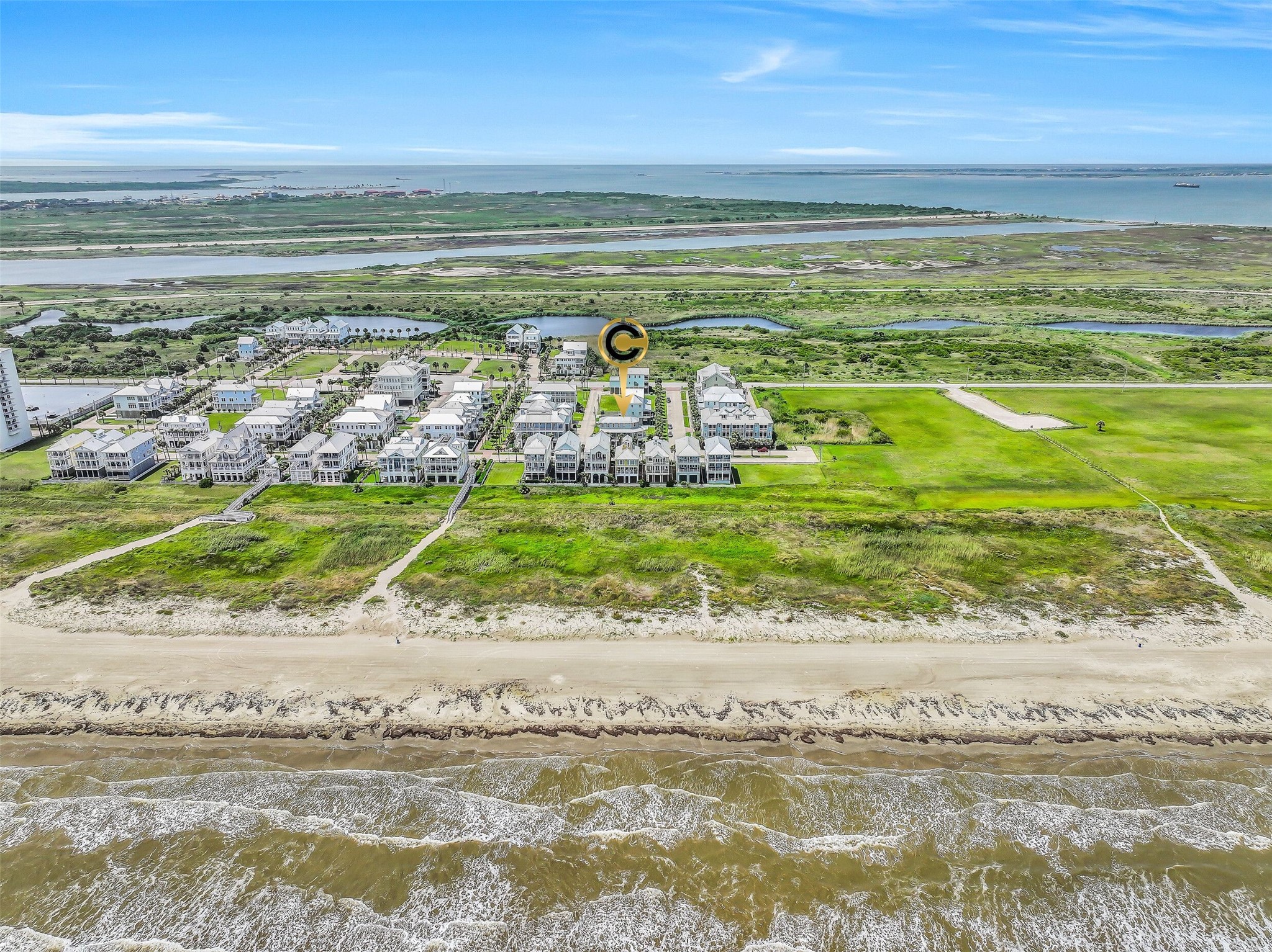 817 Positano Road Galveston, TX 77550 - Photo 50 of 50 Experience the unique setting of Beachtown from above, where charming coastal homes meet the natural beauty of Galveston's shoreline. This bird's-eye perspective captures the lifestyle, location, and character that make this community so desirable.