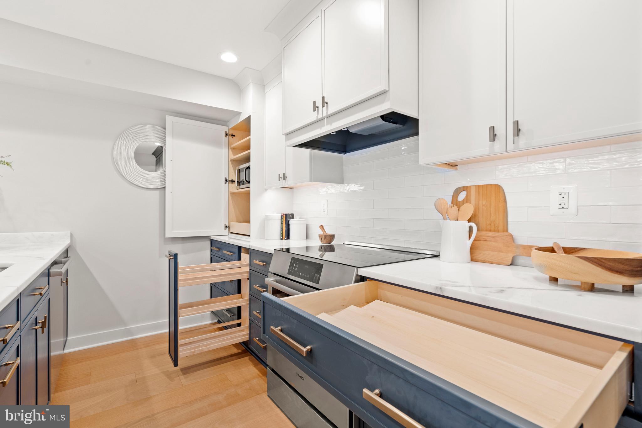 910 9th Street Northeast, Unit 1 Washington, DC 20002 - Photo 15 of 66 a kitchen with granite countertop a stove and a sink
