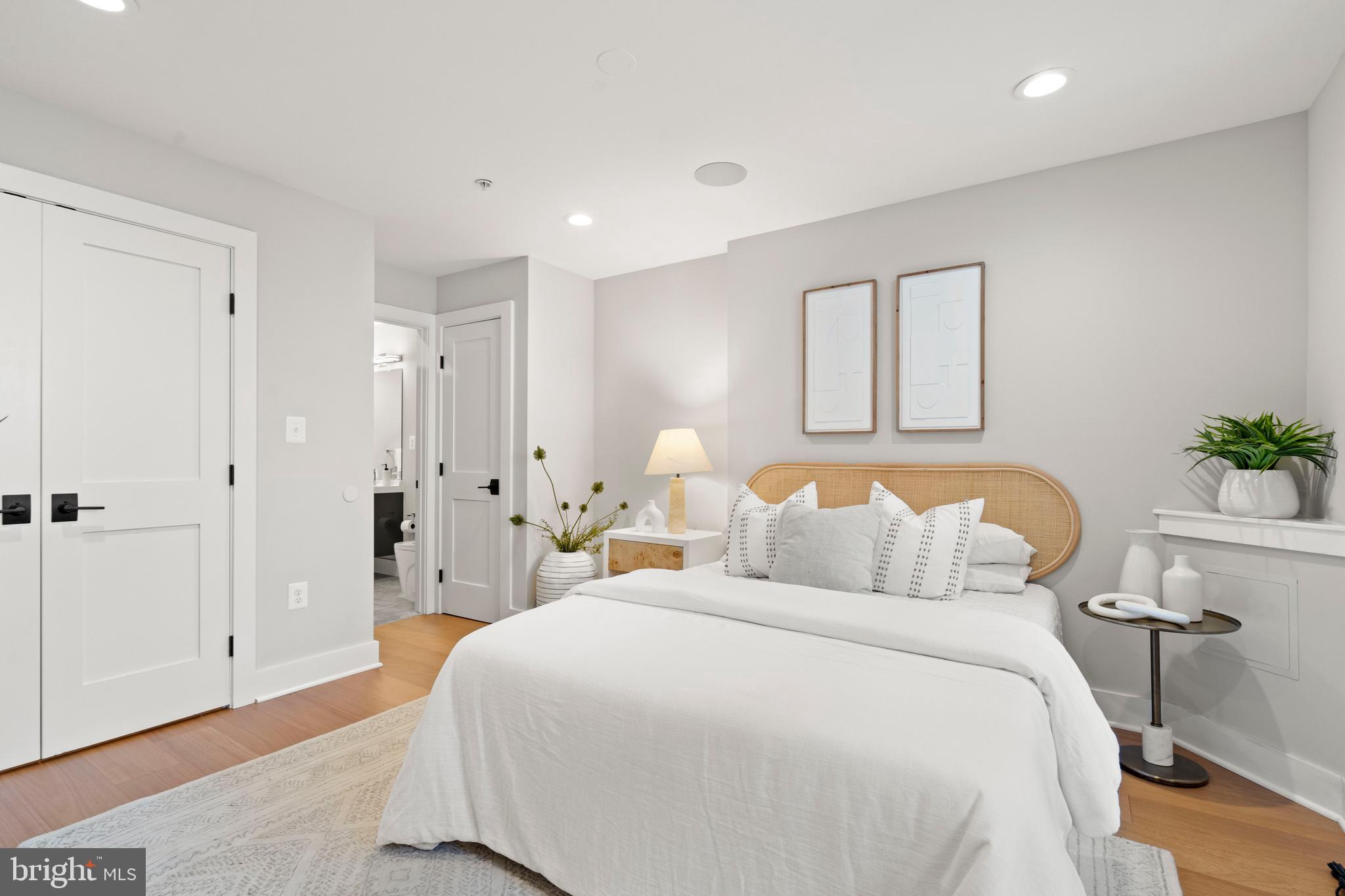 910 9th Street Northeast, Unit 1 Washington, DC 20002 - Photo 23 of 66 a bedroom with a bed and a potted plant