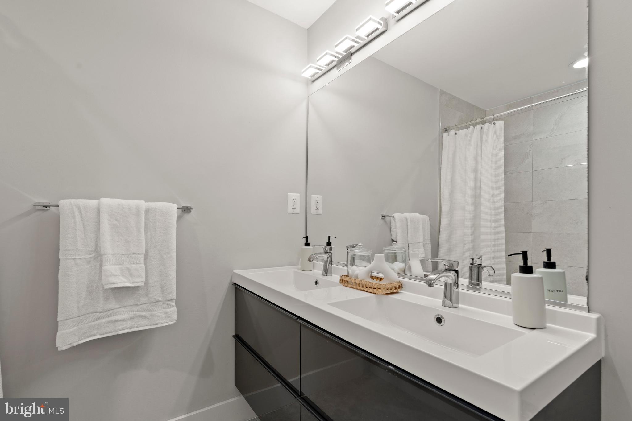 910 9th Street Northeast, Unit 1 Washington, DC 20002 - Photo 28 of 66 a bathroom with a sink and a mirror