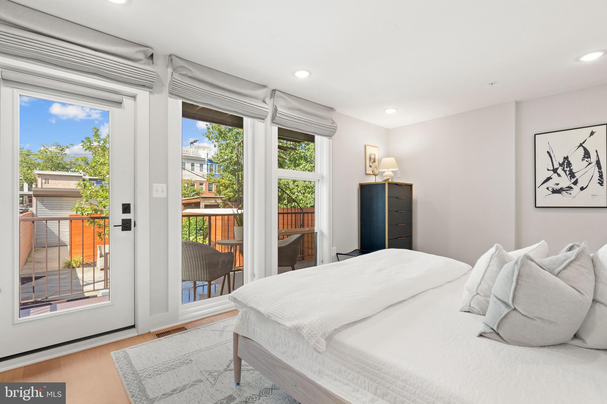 910 9th Street Northeast, Unit 1 Washington, DC 20002 - Photo 30 of 66 a large white bed in a room next to a window
