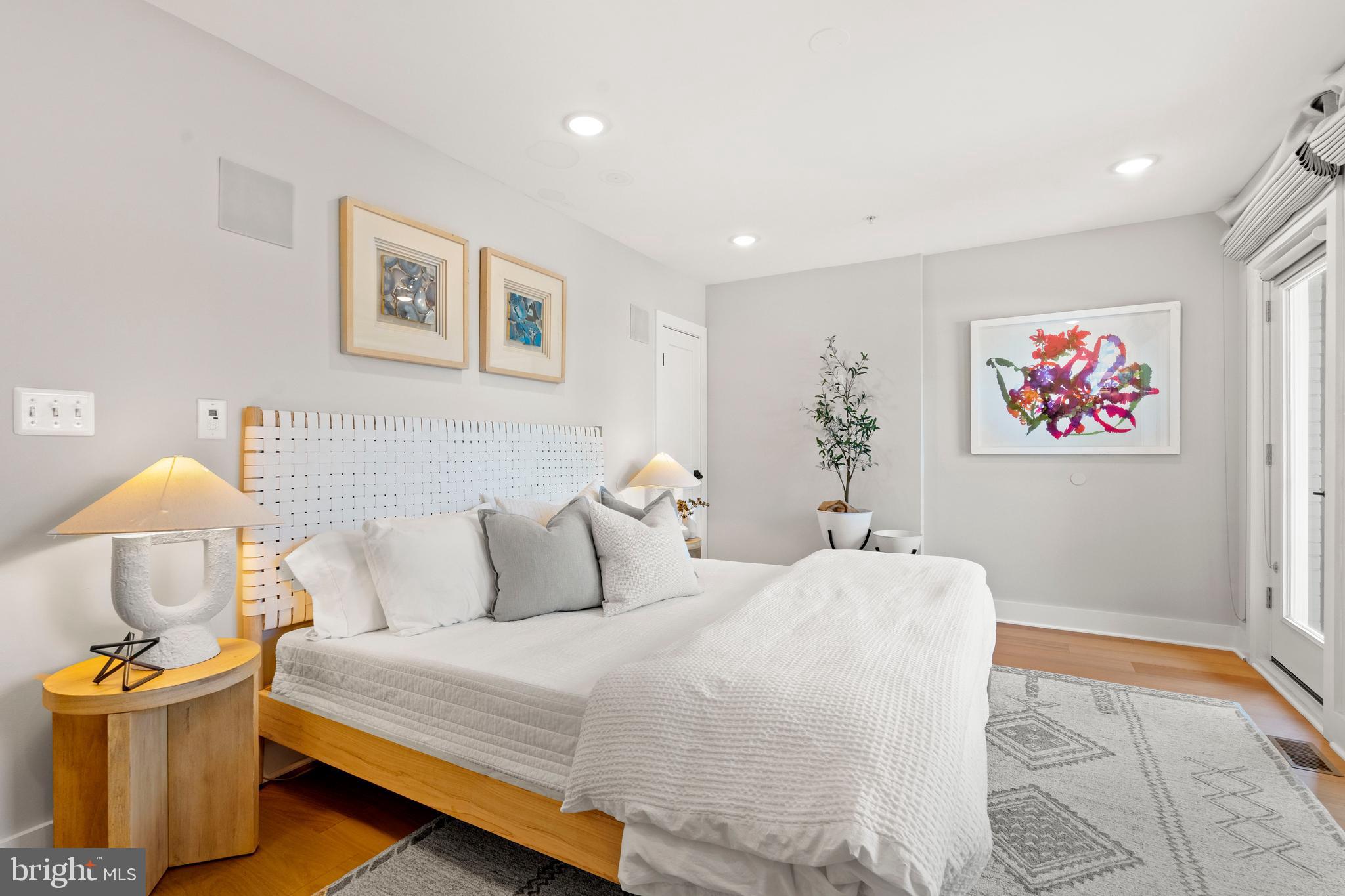 910 9th Street Northeast, Unit 1 Washington, DC 20002 - Photo 31 of 66 a bedroom with a bed and wooden floor