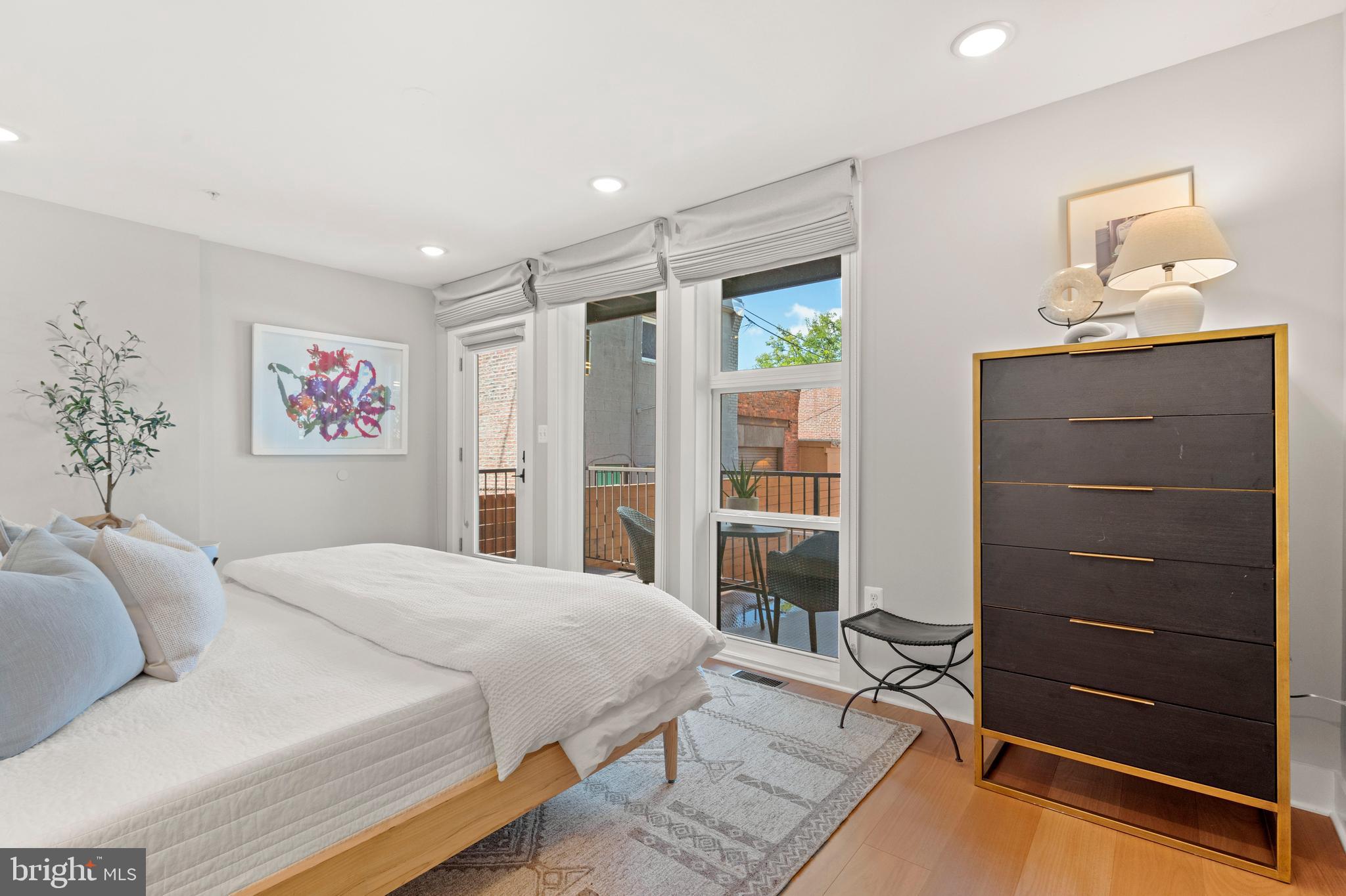 910 9th Street Northeast, Unit 1 Washington, DC 20002 - Photo 33 of 66 a spacious bedroom with a bed and a dresser