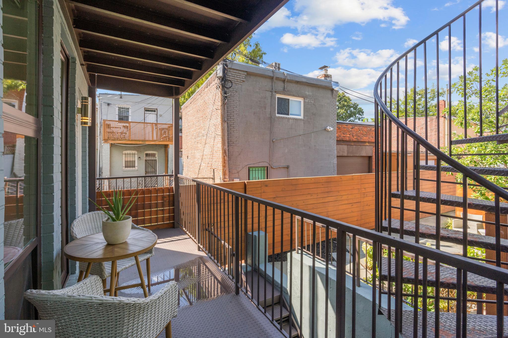 910 9th Street Northeast, Unit 1 Washington, DC 20002 - Photo 37 of 66 a view of a balcony with chairs and a potted plant
