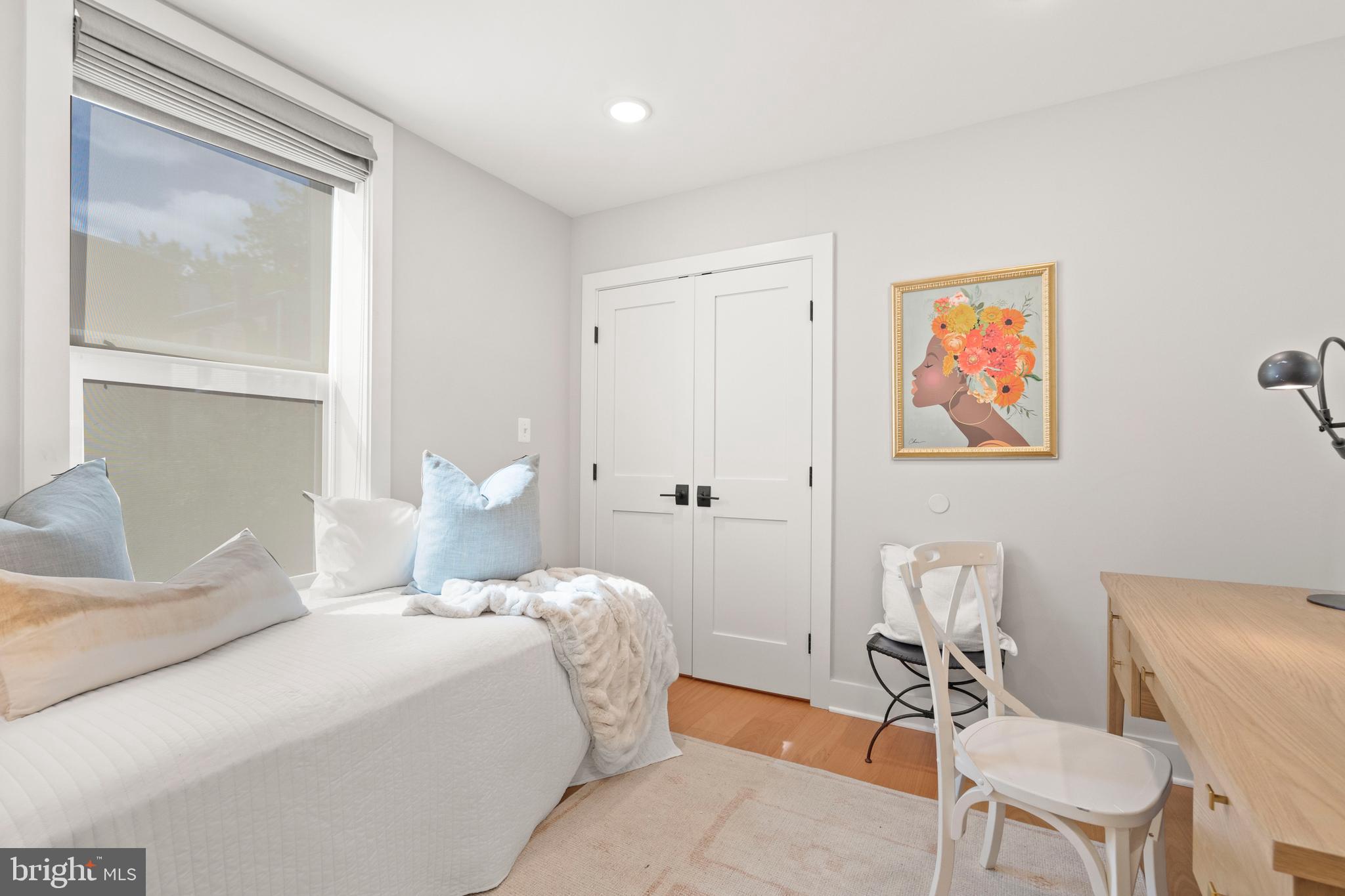 910 9th Street Northeast, Unit 1 Washington, DC 20002 - Photo 42 of 66 a bedroom with a bed and chair