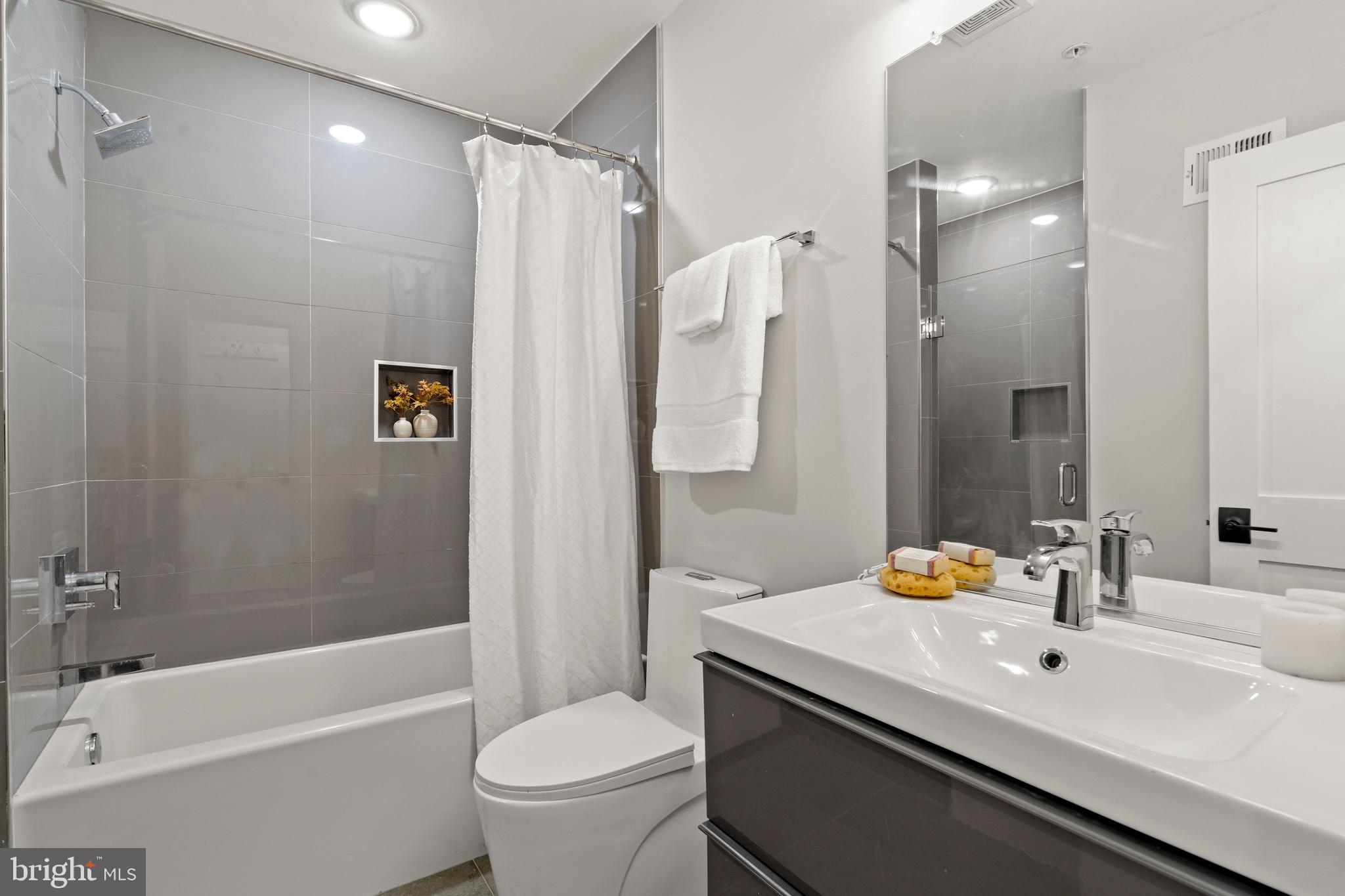 910 9th Street Northeast, Unit 1 Washington, DC 20002 - Photo 49 of 66 a bathroom with a sink a toilet and shower