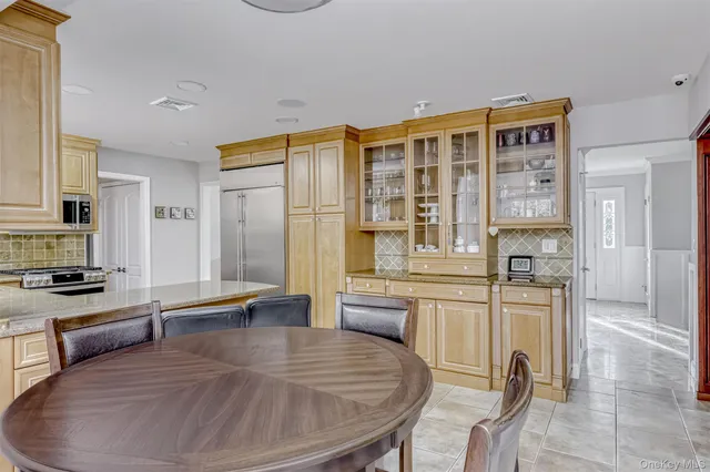 a kitchen with stainless steel appliances granite countertop a stove and white cabinets