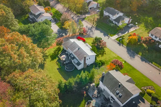 an aerial view of a house with a yard and garden