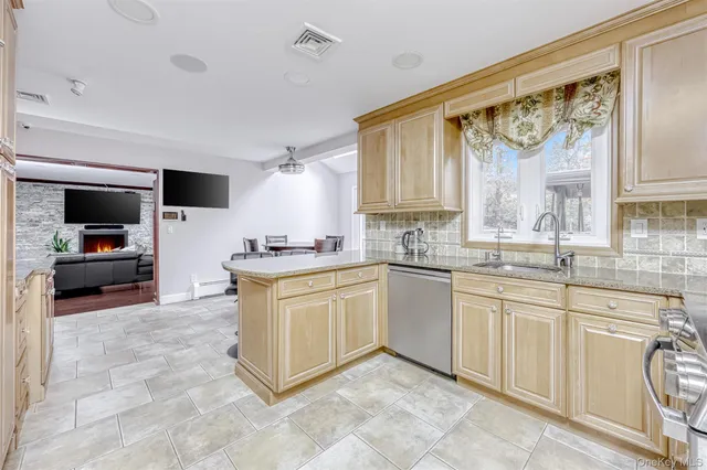 a kitchen with stainless steel appliances granite countertop a stove top oven a sink a counter top space and cabinets