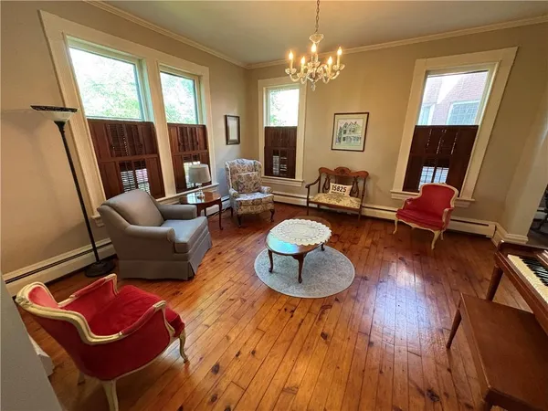 a living room with furniture and a chandelier