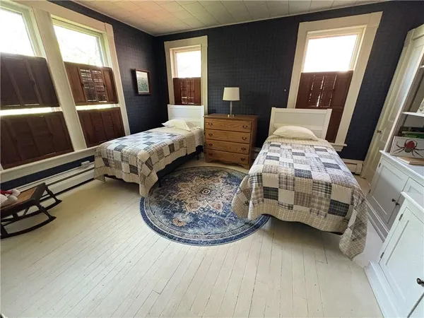 a bedroom with furniture and a window