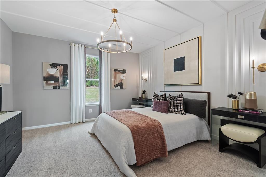 229 Ruthe Cove Locust Grove, GA 30248 - Photo 11 of 56 a bedroom with a bed and a chandelier
