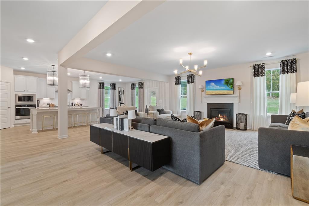 229 Ruthe Cove Locust Grove, GA 30248 - Photo 12 of 56 a living room with fireplace furniture and a chandelier
