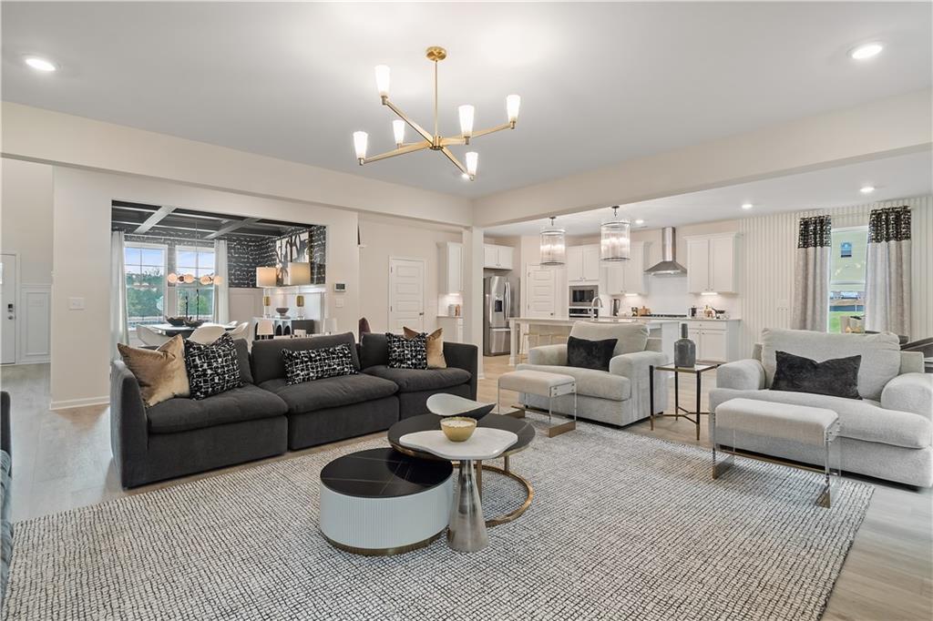 229 Ruthe Cove Locust Grove, GA 30248 - Photo 16 of 56 a living room with furniture and a chandelier