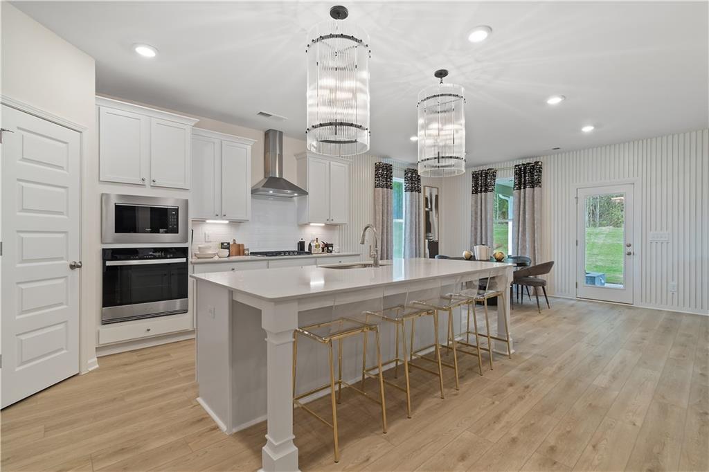 229 Ruthe Cove Locust Grove, GA 30248 - Photo 17 of 56 a kitchen with stainless steel appliances kitchen island granite countertop a stove a sink and a refrigerator