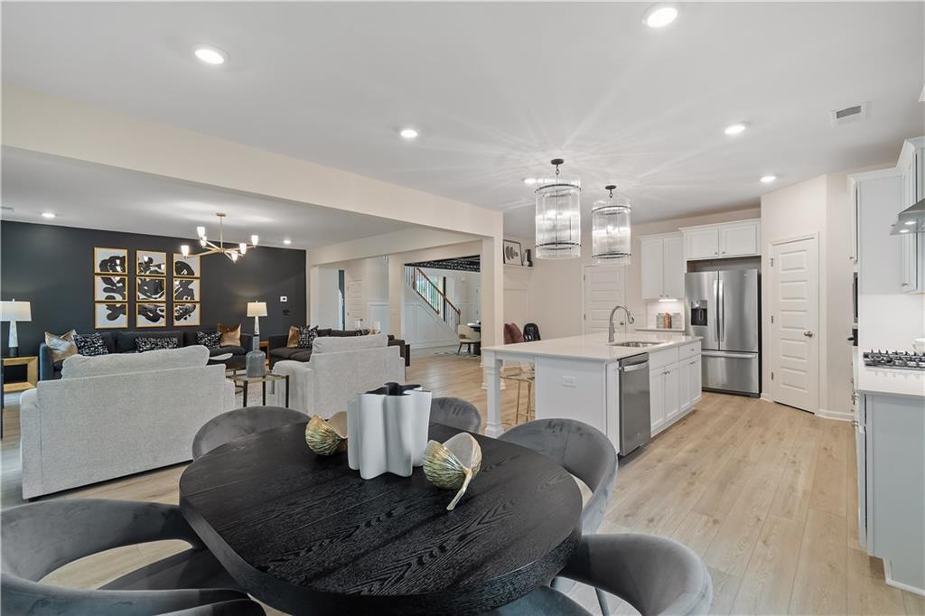 229 Ruthe Cove Locust Grove, GA 30248 - Photo 21 of 56 a kitchen with white cabinets and refrigerator