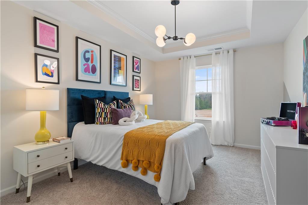 229 Ruthe Cove Locust Grove, GA 30248 - Photo 28 of 56 a bedroom with a bed and a chandelier