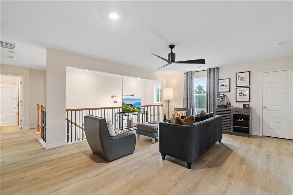 229 Ruthe Cove Locust Grove, GA 30248 - Photo 32 of 56 a living room with furniture and flat screen tv