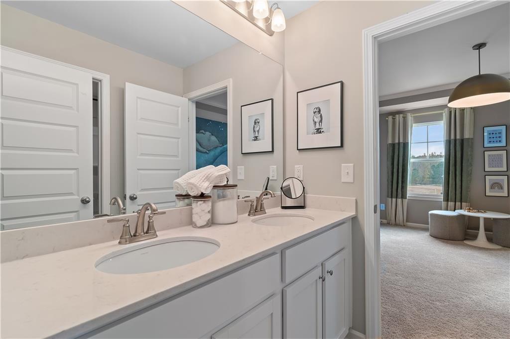 229 Ruthe Cove Locust Grove, GA 30248 - Photo 37 of 56 a bathroom with a granite countertop sink a mirror and a