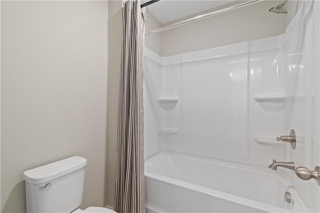 229 Ruthe Cove Locust Grove, GA 30248 - Photo 38 of 56 a bathroom with a bathtub and a toilet