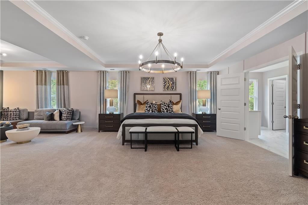 229 Ruthe Cove Locust Grove, GA 30248 - Photo 39 of 56 a bedroom with furniture and a chandelier