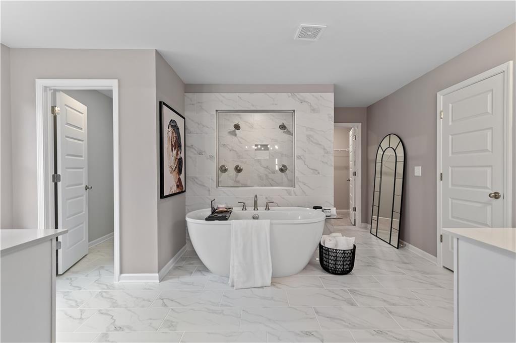 229 Ruthe Cove Locust Grove, GA 30248 - Photo 46 of 56 a spacious bathroom with a bathtub and shower
