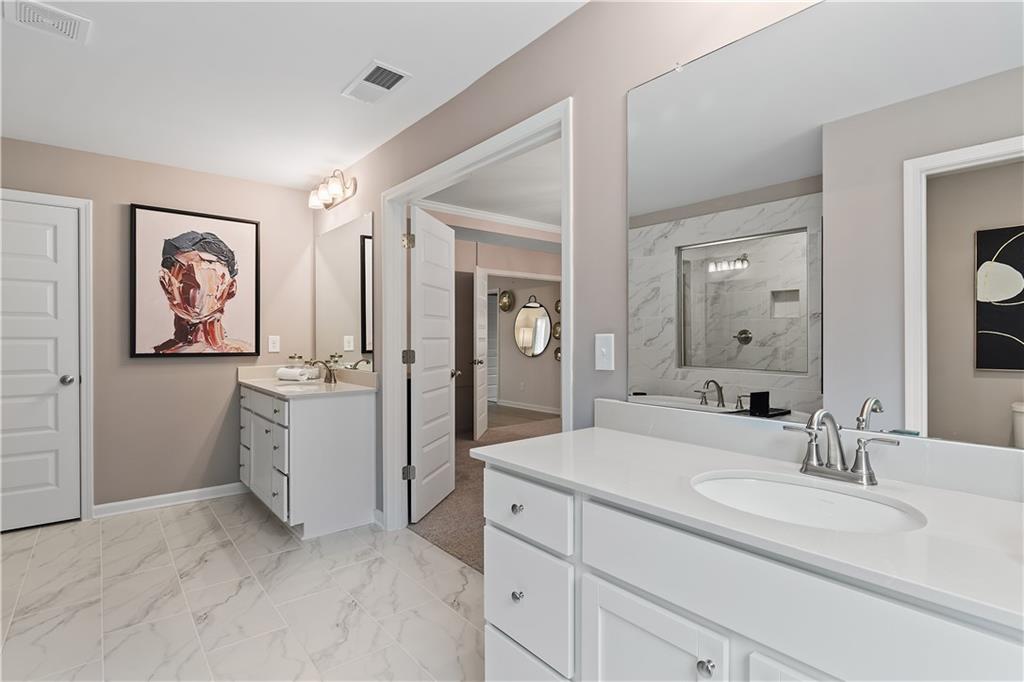 229 Ruthe Cove Locust Grove, GA 30248 - Photo 48 of 56 a bathroom with a granite countertop sink mirror and a