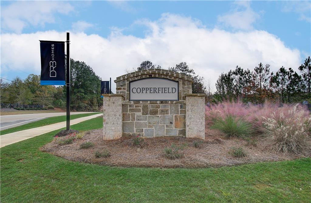 229 Ruthe Cove Locust Grove, GA 30248 - Photo 55 of 56 a view of a park with plants and a bench