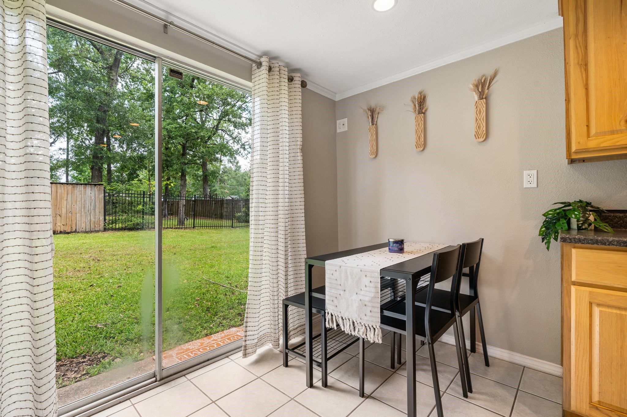 14758 Kirbee Drive Conroe, TX 77302 - Photo 11 of 35 Enjoy serene breakfasts on the first floor in a cozy nook with a scenic view of the lush backyard through sliding glass doors.