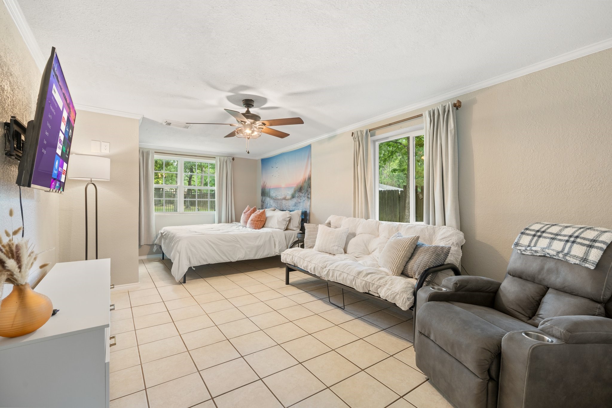 14758 Kirbee Drive Conroe, TX 77302 - Photo 12 of 35 This inviting first-floor master bedroom boasts a cozy sitting area, perfect for relaxation and comfort.