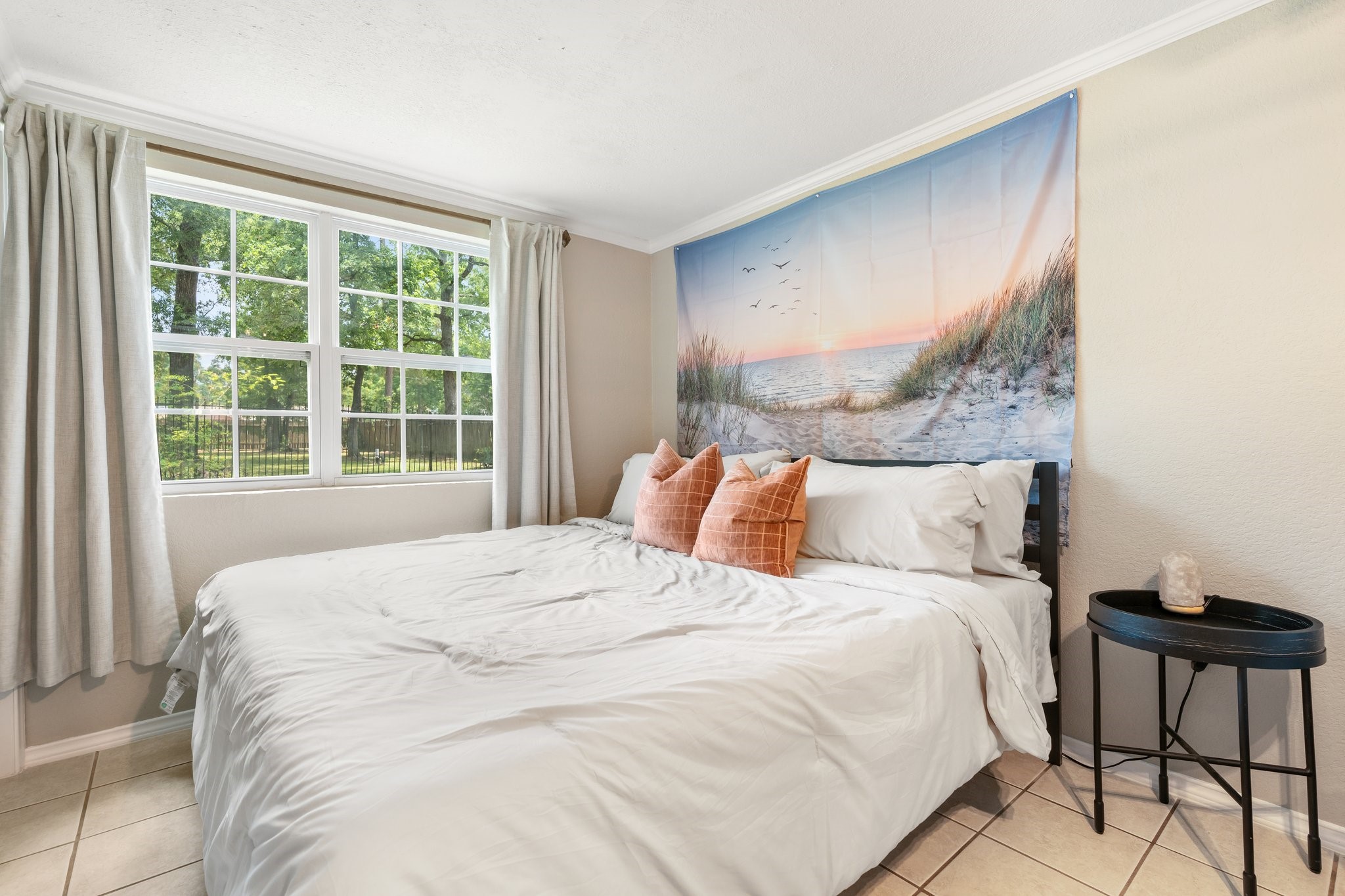 14758 Kirbee Drive Conroe, TX 77302 - Photo 14 of 35 Experience serene comfort in this first-floor master bedroom, featuring abundant natural light and a tranquil ambiance perfect for relaxation.
