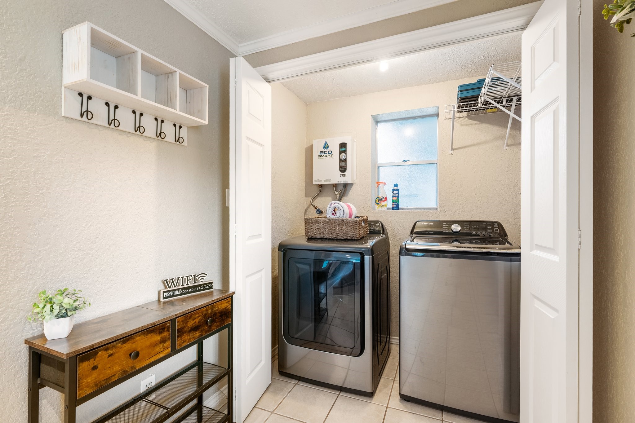 14758 Kirbee Drive Conroe, TX 77302 - Photo 18 of 35 This first-floor utility room features a sleek tankless water heater, seamlessly combining modern convenience with efficient design.
