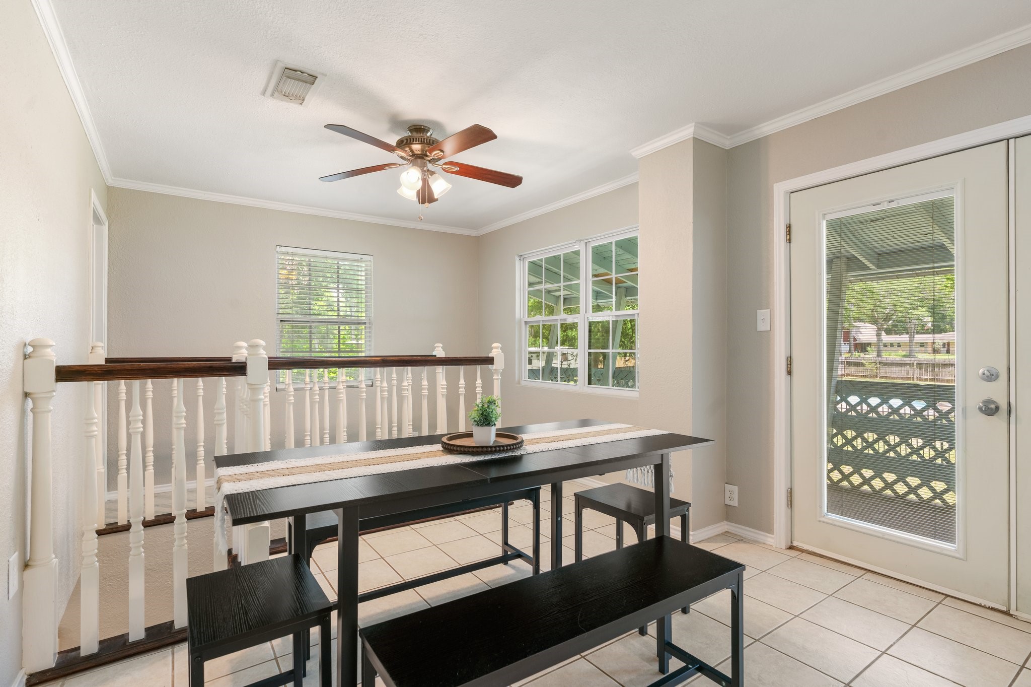 14758 Kirbee Drive Conroe, TX 77302 - Photo 21 of 35 Experience cozy dining with French doors opening to an upstairs covered patio, offering stunning views of the lush yard and sparkling pool.