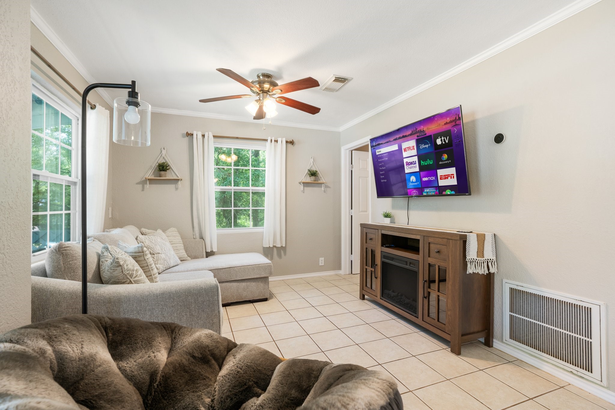 14758 Kirbee Drive Conroe, TX 77302 - Photo 22 of 35 This inviting second-floor living area features abundant natural light, a comfortable sectional sofa, and a sleek entertainment setup, perfect for relaxation and entertainment.