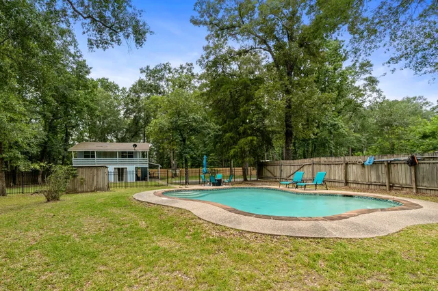 a view of a house with swimming pool and sitting area