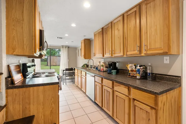 a kitchen with stainless steel appliances granite countertop a stove and a microwave