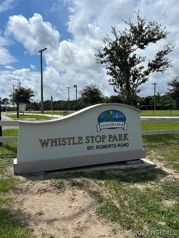 a front view of a building with sign board