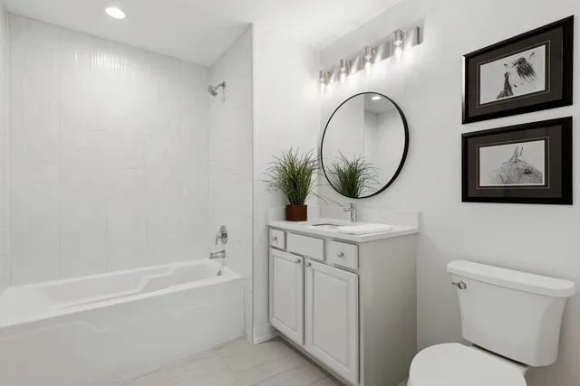 a bathroom with a toilet a sink and a mirror