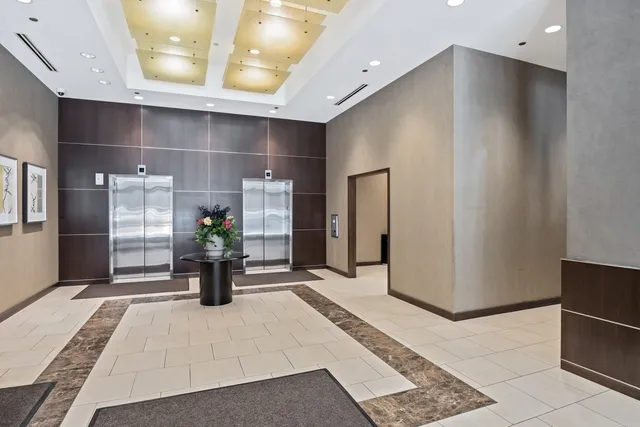 a lobby with furniture and a rug