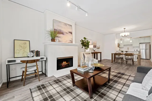 a living room with furniture a table and a fireplace