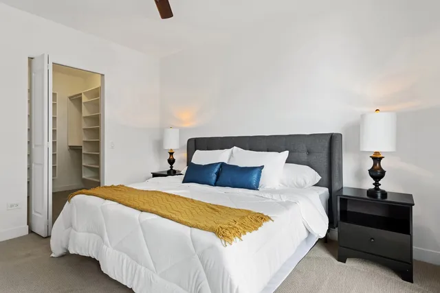 a bedroom with a bed and a night stand